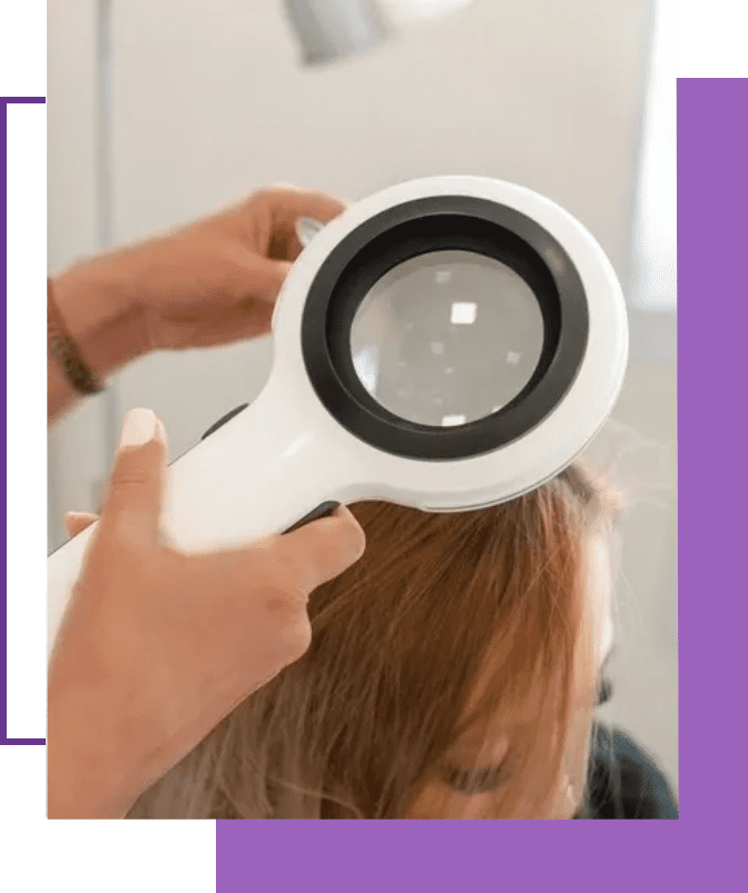 A person is using a magnifying glass to check the hair.