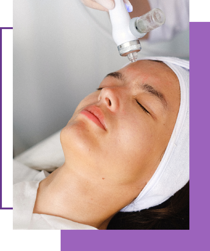 A woman getting her face cleaned with an electric device.