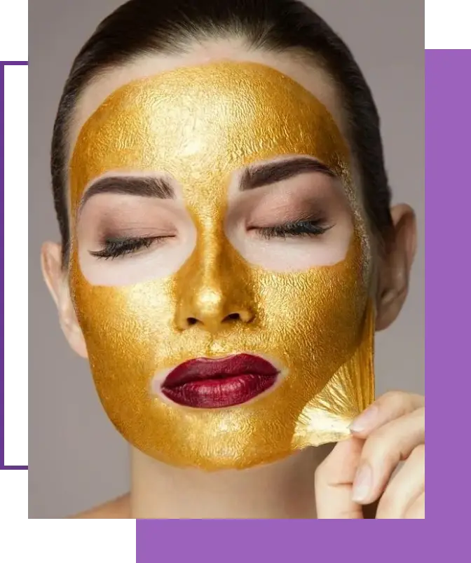 A woman with gold face mask on her face.