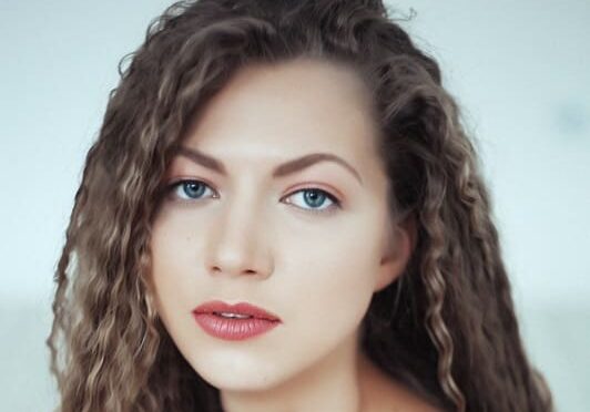 A woman with long hair and blue eyes.