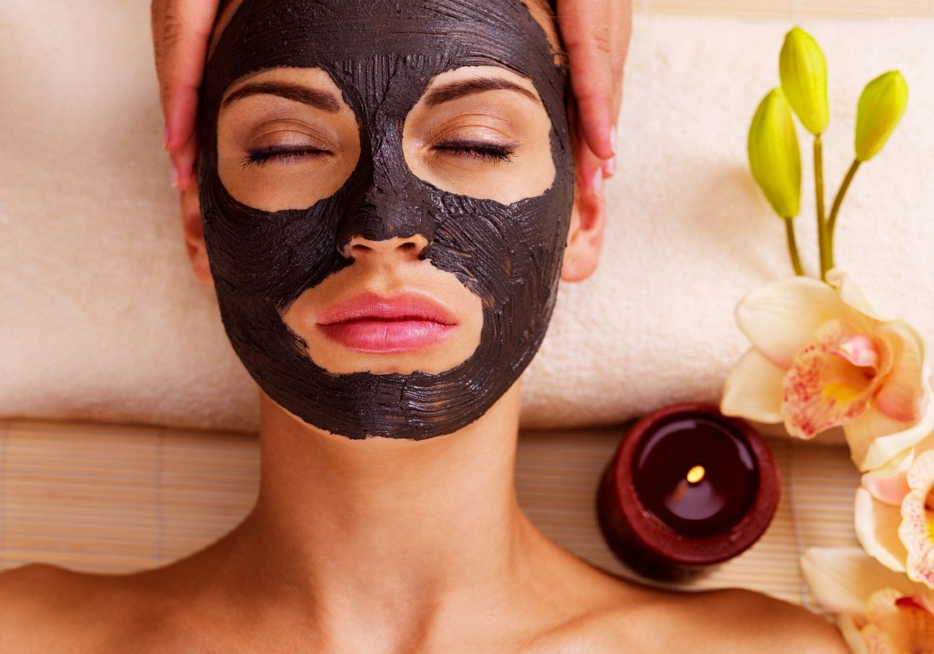 A woman with black face mask on getting her hair cut.