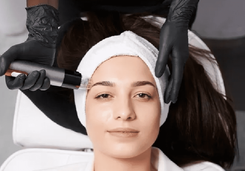 A woman getting her face waxed by an esthetician.